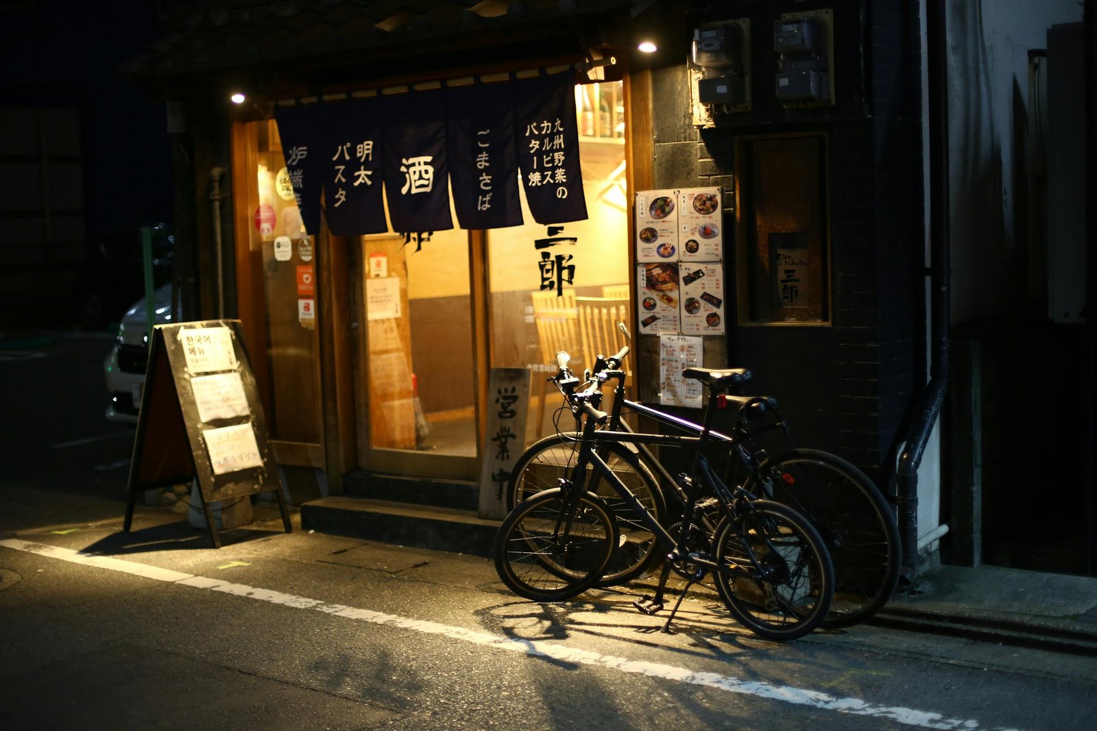 Bicycles parked outside a traditional Japanese restaurant in Fukuoka city, Japan.